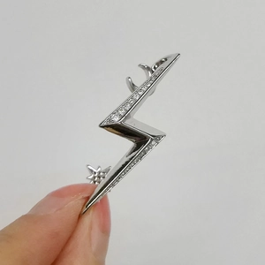 Detail of silver lightning bolt ear cuff with sparkling cubic zirconia moon and stars
