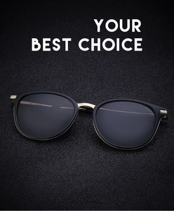 Detail of vintage polarized sunglasses with gold metal bridge on textured black background