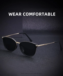 Detailed close-up of retro polarized sunglasses with gold metal frame and black lenses