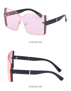 Vue détaillée de lunettes de soleil roses sans monture avec branches texturées noir et or