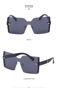 Gros plan de lunettes de soleil noires surdimensionnées avec détails dorés et branches ciselées
