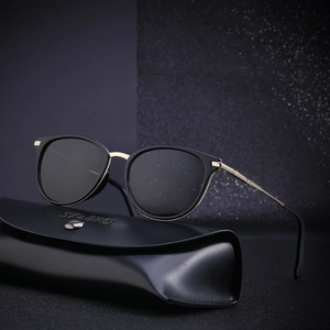 Classic black and gold polarized sunglasses with premium leather case on dark background