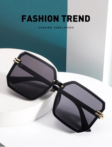 Detail of square oversized sunglasses TR7007 showing golden metal trim on the temple