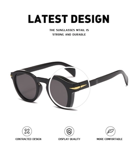 Close-up of golden arrow hinge detail on black vintage round frame sunglasses