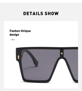 Detail view of large black square sunglasses with decorative gold studs on the frame