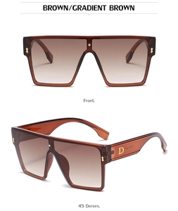 Detail of oversized brown square sunglasses with gold D-logo and gradient lenses