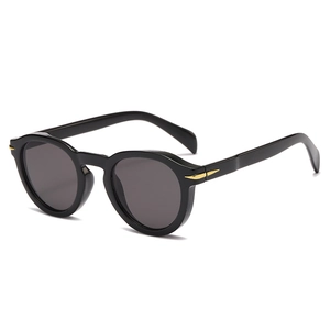 Retro black round frame sunglasses with gold arrow metal accents at 45-degree angle
