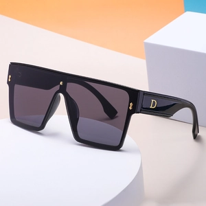 Fashionable oversized black sunglasses with gold D-logo on temple and dark gray lenses