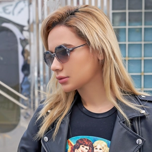 Close-up of geometric polygonal sunglasses with gradient lenses on model's face