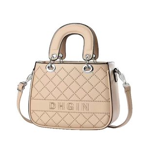 Beige quilted handbag with DHGIN embroidery and silver hardware on white background