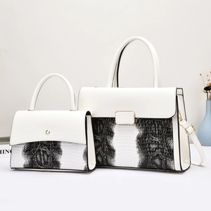 Détails de deux sacs à main monochromes en similicuir crocodile avec boucles dorées