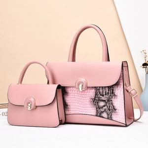 Close-up of pink two-piece handbag set with animal texture and gold ring buckle