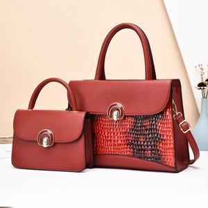 Deep red snakeskin embossed leather tote bag set with gold round buckle and shoulder strap