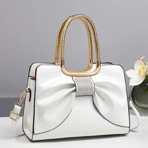 White glossy leather handbag with crystal bow and crocodile embossing for women