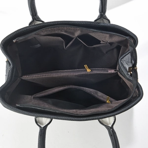 Interior view of black litchi grain tote showing three compartments and gold zipper pockets