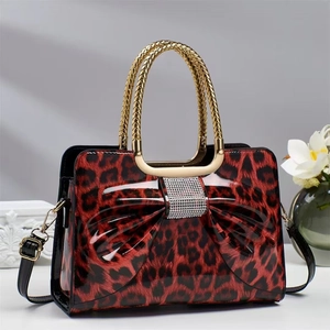 Red leopard patent leather crossbody bag with rhinestone bow and gold chain handle