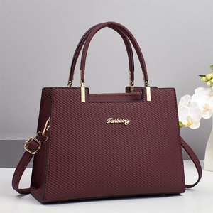Classic wine red crossbody handbag with textured fabric finish and gold hardware accents