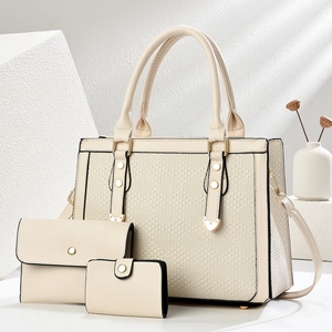 Three-piece beige handbag set featuring woven texture panels and luxury gold hardware