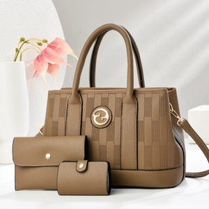 Detailed view of brown litchi pattern leather bag set with gold G logo and 3D textures