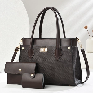Detailed view of dark brown textured 3-piece bag set with gold hardware and strap