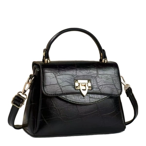 Black crocodile embossed leather handbag with gold metal lock and top handle