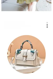 Detail of cream flap bag with gold rectangular lock and patterned silk scarf handle