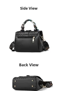 Detail view of black leather handbag with silk scarf handle and golden bottom studs