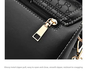 Detail of embossed black leather handbag with premium golden zipper and smooth closing