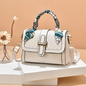 Chic beige crossbody bag with textured patterns and an elegant silk scarf handle decoration
