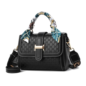 Elegant black embossed handbag with silk scarf handle and golden H-lock buckle