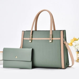 Detail of green striped tote bag with matching wallet and embossed geometric patterns