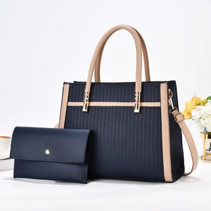 Striped navy blue tote bag set with minimalist clutch and gold hardware details