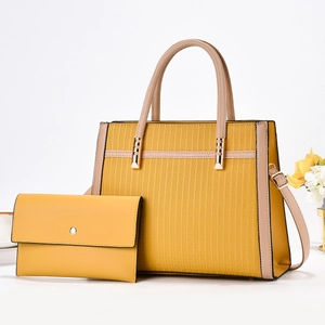 Detail of yellow striped tote bag with matching envelope wallet and textured G-patterning