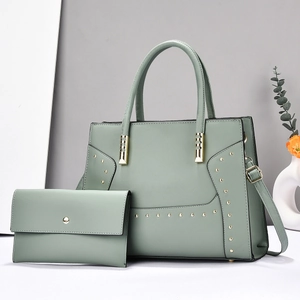 Sage green tote bag set with decorative gold rivets and matching long envelope wallet