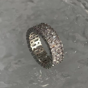 Macro detail of silver ring featuring double row of rectangular baguette-cut crystals