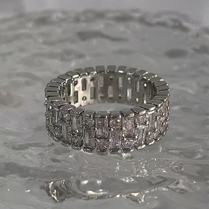 Macro shot of silver eternity ring with baguette and round-cut cubic zirconia crystals