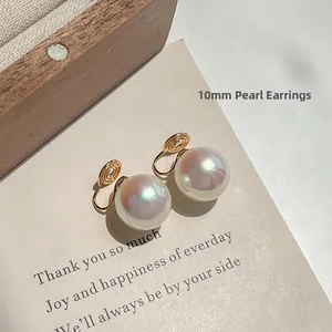 Detail of 10mm round pearl clip-on earrings with gold-plated mosquito coil backs