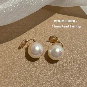 Detailed view of 12mm white pearls on golden clip-on earrings for non-pierced ears