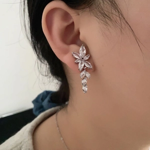 Elegant silver flower tassel earrings with sparkling zircon crystals on a model