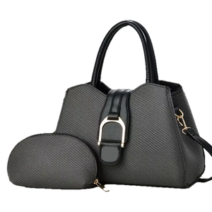 Grey textured tote bag set with black leather trim and golden horseshoe hardware