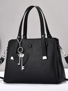 Litchi pattern black tote bag with silver heart charm and adjustable shoulder strap