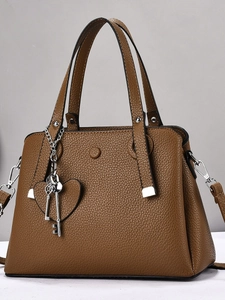 Brown lychee texture leather tote bag with silver hardware and heart key charms