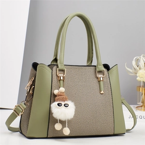 Detail der Macaron-Tasche mit Leder-Patchwork, Webstruktur und Plüsch-Anhänger