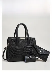Detailed view of 3-piece black lizard texture tote bag set with elegant silver hardware