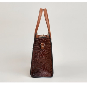 Side view detail of brown lizard-pattern tote bag showing texture and metal D-ring