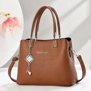 Brown litchi grain shoulder bag with top handles and pearl metal charm pendant