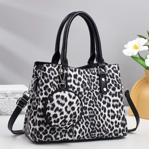 Detail of leopard print tote bag with black handles and matching round coin purse