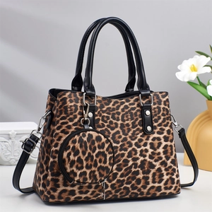 Detail of leopard print tote bag with matching round coin purse and silver hardware