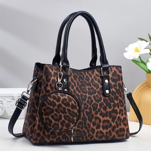 Detailed view of leopard print tote bag with round coin purse and black leather handle
