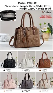 Detailed view of women's marble texture handbag with V-shaped metal hardware and tassel decor